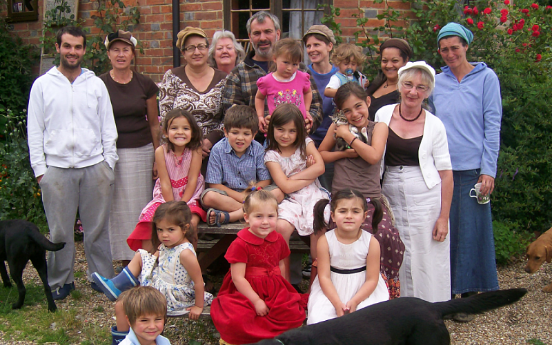 Family photo of Rabbi Philip Sharp with his six wives, illustrating active polygamy practiced within Torah law